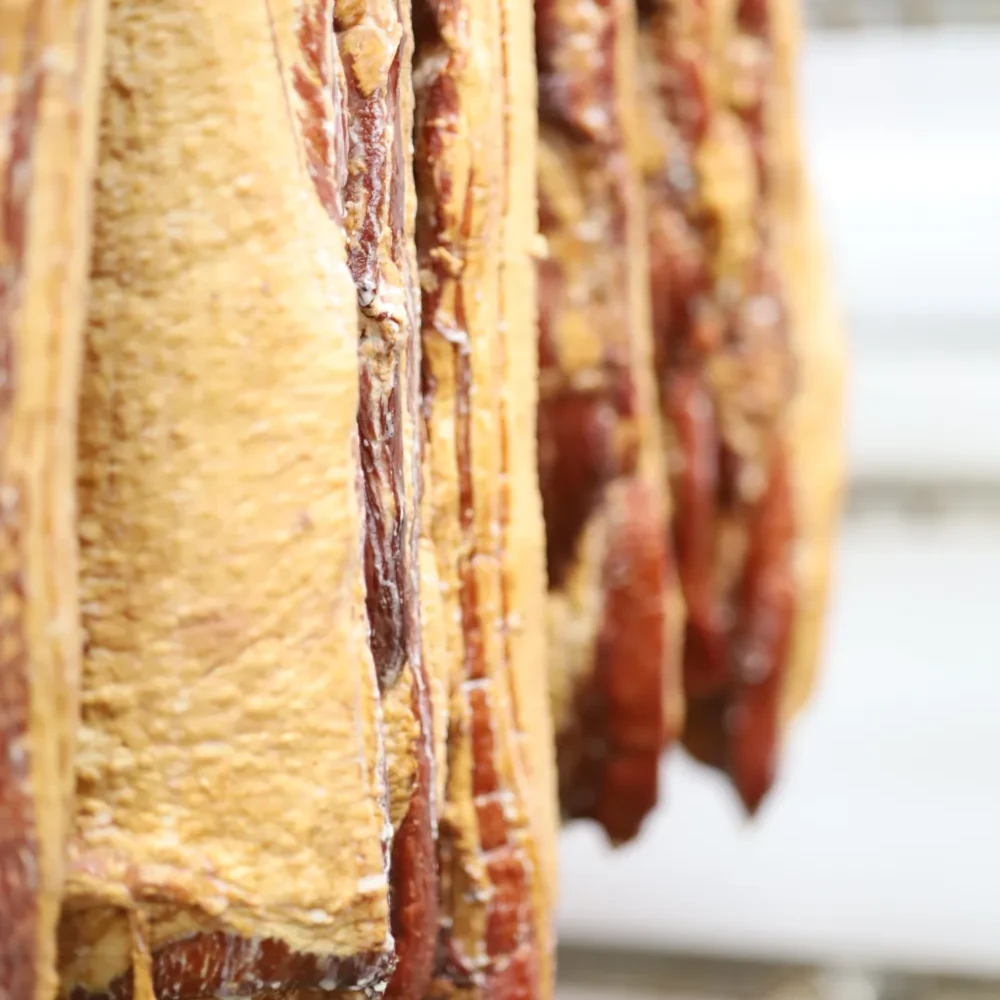 Bacon hanging to cure