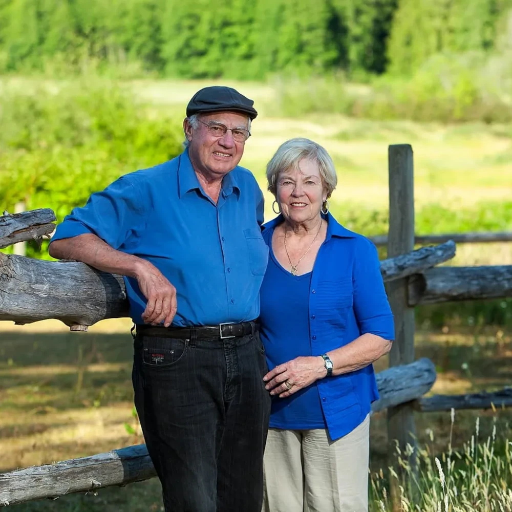 Tom and Helena Hertel leaning on fence